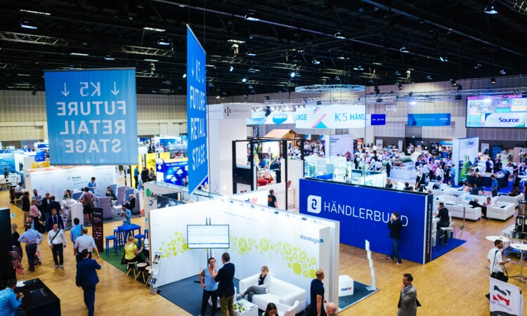 Exhibition stands with visitors in the convention hall II
